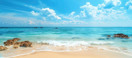 Tropical Beach With Clear Blue Water Under Blue Sky In A Summer Day