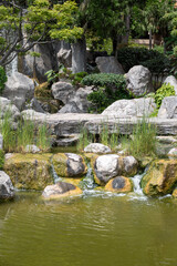 Landscape urban design, city park in Japan style with stones, bonsai pines trees, flowers, little briges, water falls in center of Monte-Carlo city, Monaco