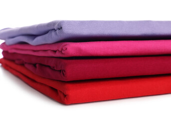 Sticker - Stack of clean colorful t-shirts isolated on white