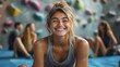 © Generative AI - Laughing young woman in sportswear sitting with other people on the floor of a bouldering gym after a rock climbing session : Generative AI