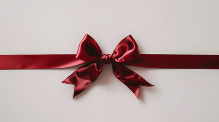 A luxury red straight diagonal ribbon with a bow over a white background