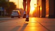 © umut hasanoglu - Silhouette of a person jogging on a city sidewalk during a golden sunrise.
