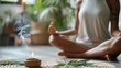 © stockdevil - Relaxed person meditating with cannabis incense burning nearby