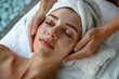 © Areerat - Young beautiful woman in spa receiving face and head massage.