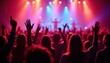 © umut hasanoglu - A vibrant concert scene with a diverse crowd of people raising their hands, illuminated by colorful stage lights, creating an energetic atmosphere.