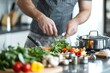 © Larisa - Man chopping vegetables for healthy meal in modern kitchen
