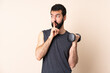 © luismolinero - Caucasian sport man with beard making weightlifting over isolated background showing a sign of silence gesture putting finger in mouth