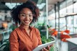 © Anjali - Young happy business woman working with tablet in corporate office