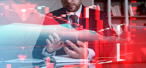 Poster - Businessman analyzing financial charts on a tablet with falling