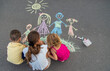 © Anna - children draw a family with chalk. Selective focus