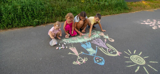 Wall Mural - children draw a family with chalk. Selective focus