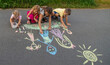 © Anna - children draw a family with chalk. Selective focus