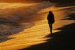 © At My Hat - Woman walks along sandy beach. A silhouette of a woman walking on the beach as the sun sets in the distance.