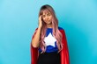 © luismolinero - Young superhero woman with pink hair isolated on blue background with headache