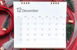© Yuphayao Pooh's - December 2024 calendar schedule , Top view shot featuring calendar with December month, little Christmas tree, glitter silver ribbon and red ribbon on red background. Chrismas and New year concept.