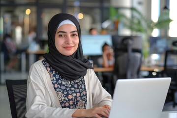 Wall Mural - Muslim woman working in modern office with colleagues.