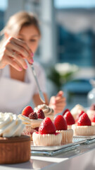 Canvas Print - Close-up of a woman's hand decorating a strawberry and whipped cream dessert