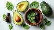 © Feeney - Fresh ripe avocado and a bowl of essential oil on a white background flat lay for healthy cooking or organic cosmetics.