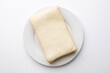 © fotoworld - Unbaked puff pastry sheet on a white plate, perfect for holiday baking or pastry recipe concept