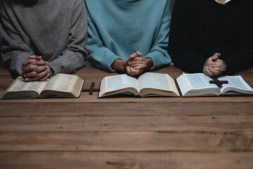 Asian men and women hands praying to god with the bible. Pray for god blessing. Religious beliefs Christian life crisis prayer to god.