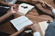 © NINENII - Asian men and women hands praying to god with the bible. Pray for god blessing. Religious beliefs Christian life crisis prayer to god.