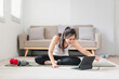 © PRIME STOCK LAB - Asian young woman doing yoga stretching exercise on mat yoga, fitness exercises. Healthy lifestyle Calmness and relax at home.