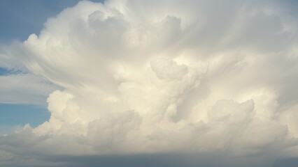 Canvas Print - Fluffy white clouds billowing in the blue sky during daylight hours