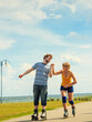 © anetlanda - Young couple on roller skates riding outdoors