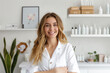 © Ирина Щукина - A woman in a white lab coat stands in front of a shelf of bottles
