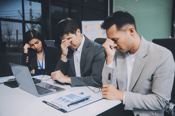 Group of colleagues engaging in a discussion during a business meeting in a conference room. Happy business people, men and women, collaborating and working towards their shared goals.