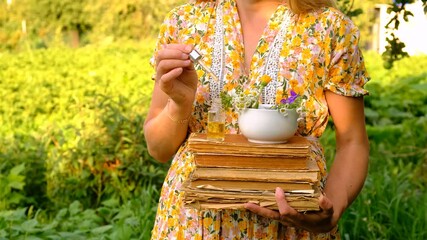 Wall Mural - Woman with medicinal herbs in the garden. Selective focus.