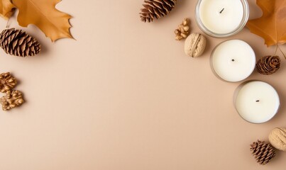 Craft paper background with autumn themed items like candles, walnuts and cones.