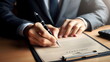 © Borneo - a close up man hand holding pen and signing legal contract agreement