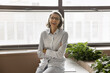 © fizkes - Laughing middle-aged professional businesswoman with short grey hair and eyeglasses posing for camera at modern workplace. Portrait of mature business consultant, project or marketing manager, career