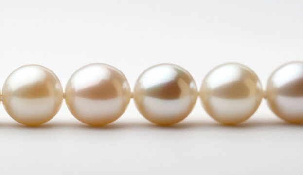 A horizontal line of pearls on a white background