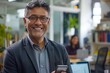 © Art Gallery - Smiling mature Latin or Indian businessman holding smartphone in office. Middle aged manager using cell phone mobile app. Digital technology application and solutions for business, Generative AI