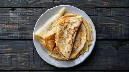 Canvas Print - Golden crepes with powdered sugar on a dark wooden table