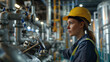 © Swaroop - A large industrial plant where chemical engineers are overseeing the production of chemicals. The focus is on a female engineer wearing safety gear, inspecting