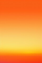 Orange light from the setting sun silhouettes mountain ridges against a colorful sky, capturing the serene beauty of a desert landscape.