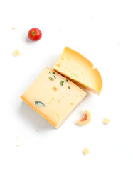 Piece of yellow cheese with herbs on white background, tomato