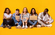 © Prostock-studio - Group of multiracial exhausted students preparing for university exams, blondy girl having great idea, yellow background, panorama