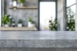 © ylivdesign - Empty concrete countertop providing space for product placement in blurred modern kitchen interior