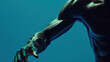 © otter2 - A close-up of an athlete's arm and hand as they prepare to sprint, muscles tensed and ready, set