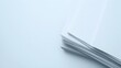 © Heng Heng - AI Stock - Overhead view of a neatly stacked pile of pristine printer paper on a plain white studio background providing a clean and minimal template for text or graphic overlay