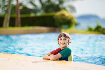 Wall Mural - Kids jump into swimming pool. Summer water fun.