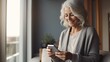 © neirfy - Beautiful happy senior woman with grey hair, using smartphone phone at home.