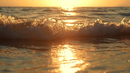 Poster - Wide shot of rolling waves in a calm sea with the sun setting in the background, creating a golden reflection