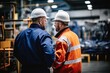 © kristina - Man in blue-collar workwear indoors, wearing orange hard hat and high-visibility clothing. Construction worker with personal protective equipment including helmet.