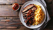 © Michael - Barbecue sauce being poured over sliced brisket with a side of macaroni and cheese