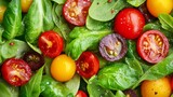 A close-up image of a fresh salad featuring vibrant cherry tomatoes, spinach leaves, and yellow tomatoes. The colors and textures of the ingredients create a visually appealing and appetizing composit